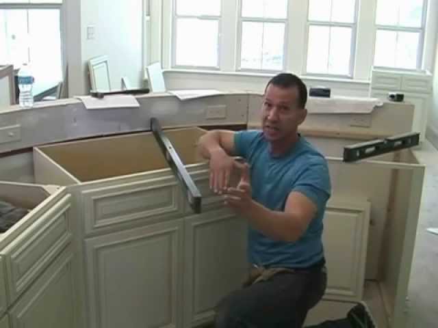 Instructions on installing base cabinets with a corner sink.