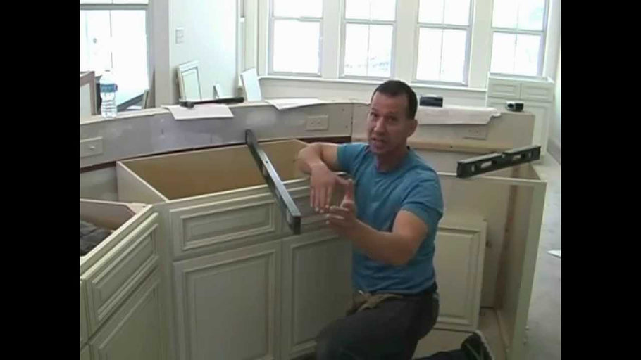 Instructions on installing base cabinets with a corner sink.